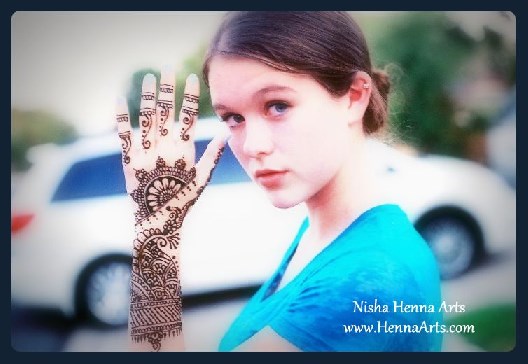 beautiful girl posing with henna tattoo on hand