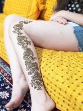 Flower henna designs on the leg calf