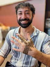 Henna is not for women only. A man happily showing his henna